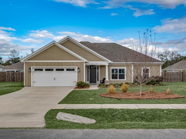 view of front of home featuring a front yard and a garage