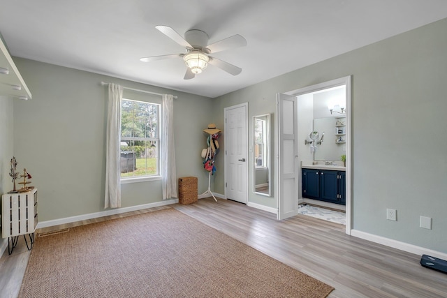 entryway with light wood-type flooring, ceiling fan, and baseboards