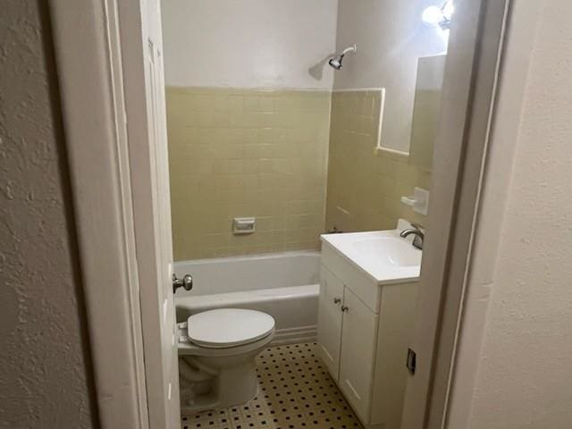 bathroom with toilet, shower / tub combination, and vanity