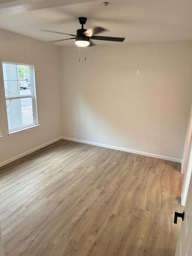 unfurnished room with ceiling fan and light wood-type flooring