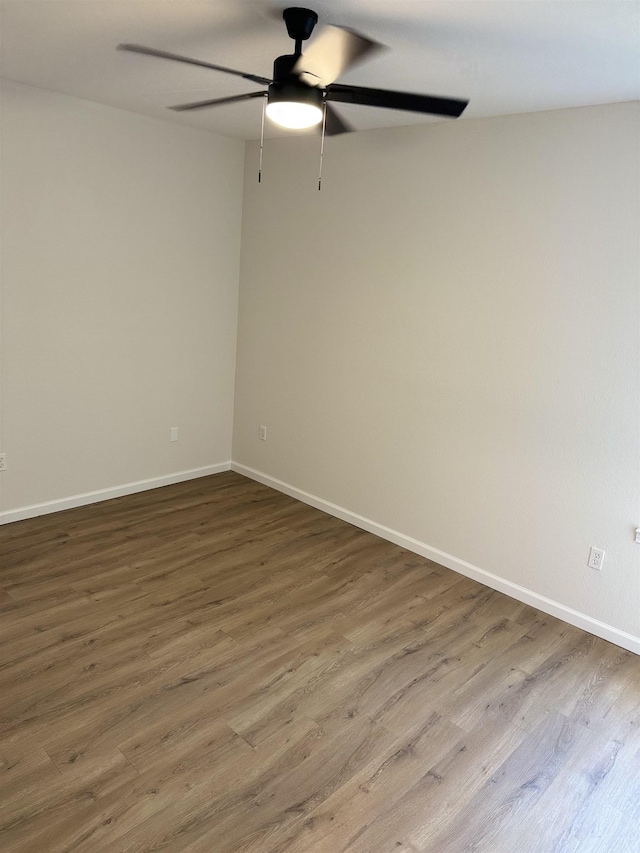 unfurnished room with ceiling fan and hardwood / wood-style flooring