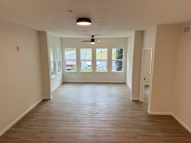 empty room featuring dark hardwood / wood-style floors and ceiling fan