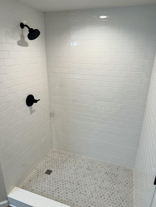 bathroom with a tile shower