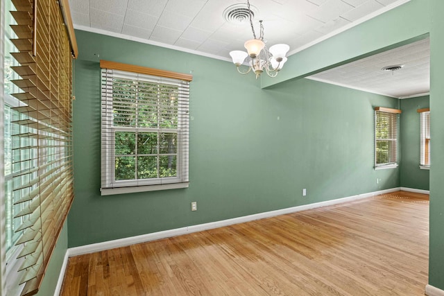 615 N Calhoun St, Quincy, FL 32351 - empty room featuring ornamental molding, a chandelier, and wood finished floors
