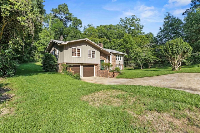 615 N Calhoun St, Quincy, FL 32351 - view of front of property with driveway, brick siding, a front lawn, a garage, and a chimney