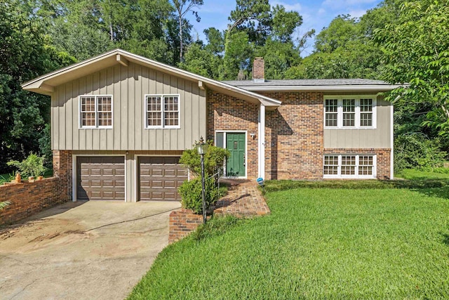 615 N Calhoun St, Quincy, FL 32351 - raised ranch with a chimney, driveway, a garage, a front lawn, and brick siding
