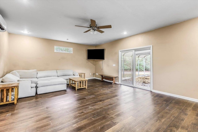 living room with ceiling fan and dark hardwood / wood-style floors