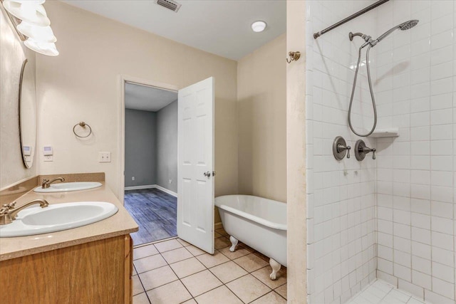 bathroom featuring tile patterned floors, separate shower and tub, and vanity