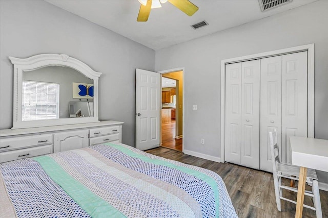 bedroom with a closet, dark hardwood / wood-style floors, and ceiling fan