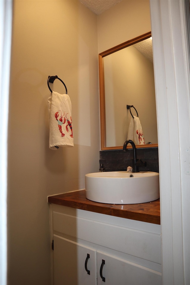 bathroom with vanity and a textured ceiling