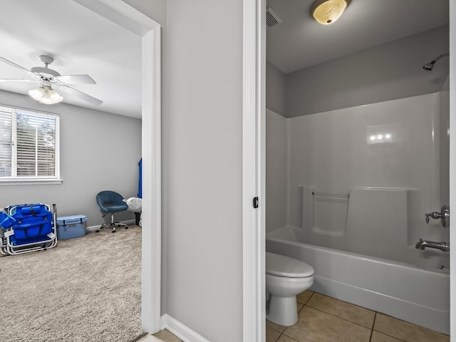 bathroom with toilet, tile patterned flooring, ceiling fan, and washtub / shower combination