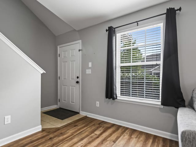 foyer with lofted ceiling and hardwood / wood-style flooring