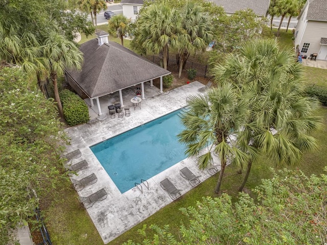 view of pool with an outdoor bar and a patio