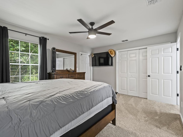 bedroom with ceiling fan and light carpet