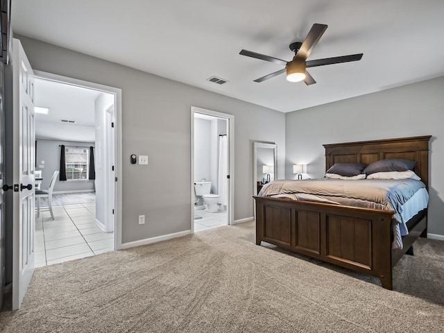 bedroom with ensuite bathroom, ceiling fan, and light colored carpet