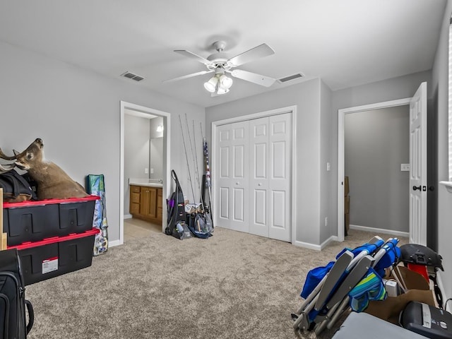 interior space featuring ceiling fan, a closet, and connected bathroom