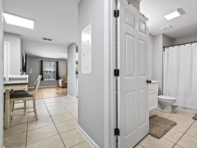 bathroom with toilet and tile patterned flooring