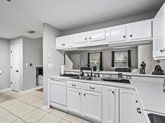 kitchen with white cabinets, light tile patterned flooring, dishwasher, and sink