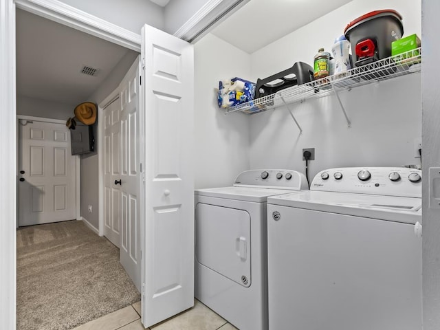 laundry area featuring light carpet and washing machine and clothes dryer