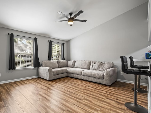 living room with wood-type flooring and ceiling fan