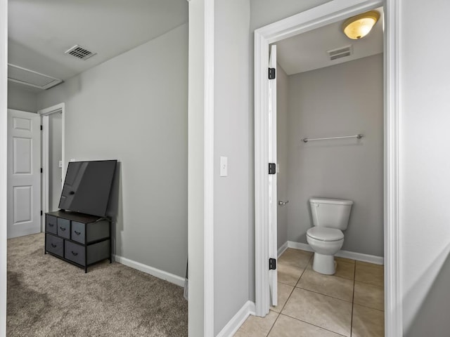 bathroom with toilet and tile patterned flooring