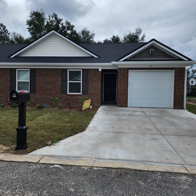 single story home with a garage and a front lawn