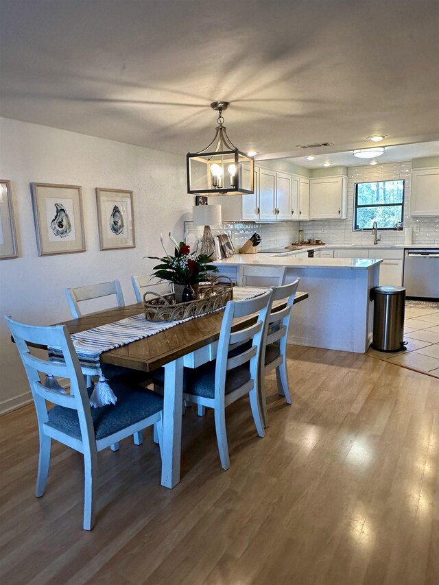2289 Surf Rd Unit B4, Ochlockonee Bay, FL 32346 - dining space featuring light wood-style flooring and a chandelier