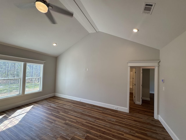 unfurnished room with vaulted ceiling with beams, dark wood finished floors, visible vents, and baseboards