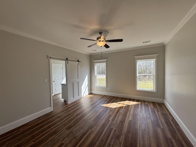 unfurnished room with baseboards, visible vents, dark wood finished floors, and crown molding