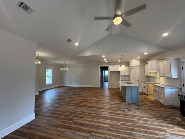 kitchen with dark wood-style flooring, a sink, visible vents, white cabinets, and open floor plan