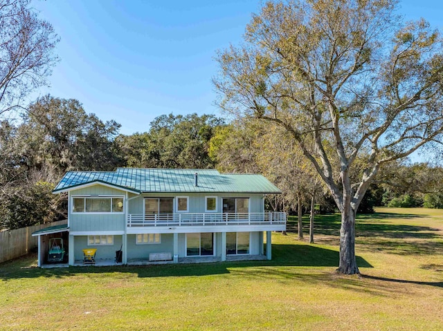 rear view of property featuring a lawn