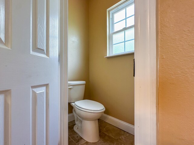 14135 98th St, Live Oak, FL 32060 - bathroom featuring toilet and baseboards