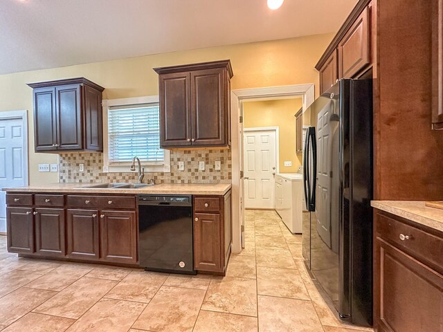 14135 98th St, Live Oak, FL 32060 - kitchen featuring black appliances, washing machine and clothes dryer, a sink, and light countertops