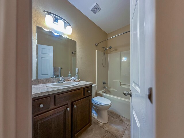 14135 98th St, Live Oak, FL 32060 - bathroom with toilet, vanity, washtub / shower combination, tile patterned floors, and a textured wall