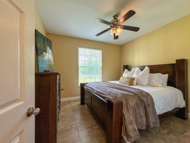 14135 98th St, Live Oak, FL 32060 - bedroom featuring a ceiling fan, light tile patterned floors, and baseboards