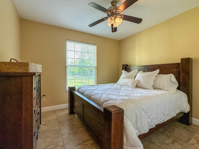 14135 98th St, Live Oak, FL 32060 - bedroom featuring baseboards, ceiling fan, and light tile patterned floors