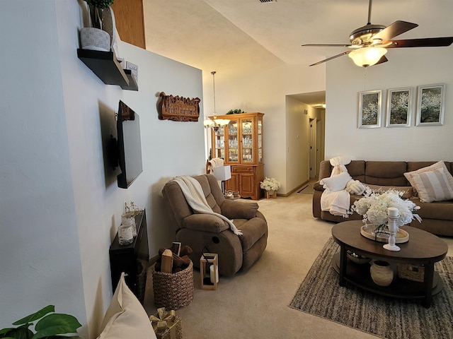 living room with light colored carpet, lofted ceiling, and ceiling fan with notable chandelier