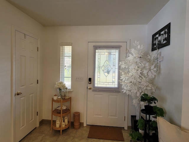 entryway with light tile patterned flooring