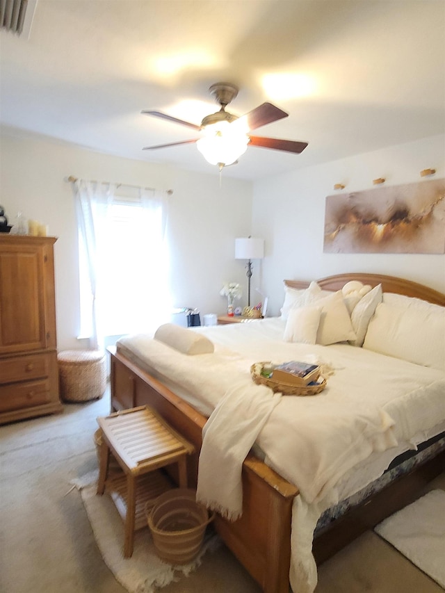 bedroom with ceiling fan and light colored carpet