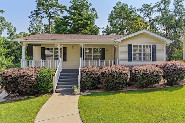 ranch-style house with a front yard and a porch