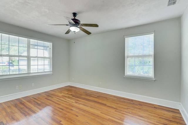 empty room with wood-type flooring and ceiling fan