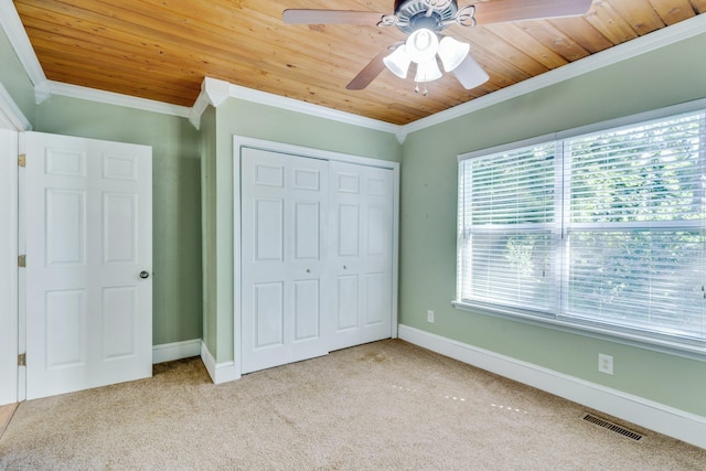 unfurnished bedroom featuring ceiling fan, ornamental molding, light carpet, and multiple windows