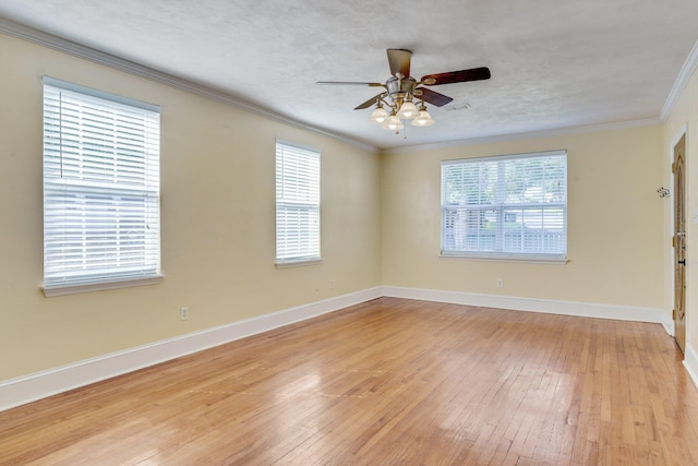 empty room featuring light wood-type flooring, ceiling fan, and crown molding