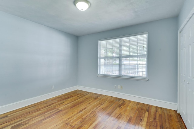 spare room with hardwood / wood-style floors