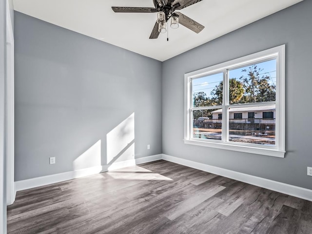 unfurnished room with dark hardwood / wood-style floors and ceiling fan