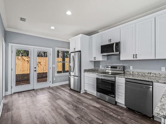 kitchen featuring white cabinetry, appliances with stainless steel finishes, dark hardwood / wood-style flooring, and light stone counters