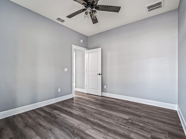 empty room featuring ceiling fan and dark hardwood / wood-style flooring