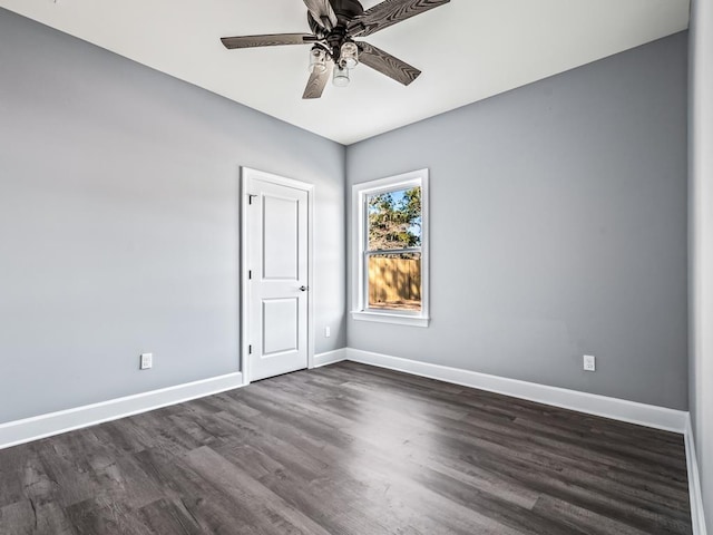 empty room featuring dark wood-type flooring and ceiling fan