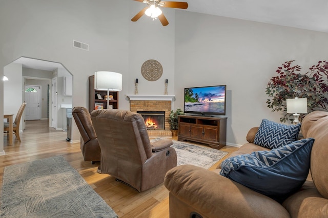 1150 Copper Creek Dr, Tallahassee, FL 32311 - living room featuring high vaulted ceiling, ceiling fan, a fireplace, light wood-style floors, and baseboards