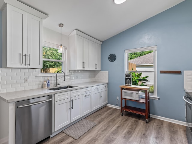 9 Pirates Cove Ln, Saint Marks, FL 32355 - kitchen featuring stainless steel dishwasher, tasteful backsplash, light countertops, light wood-style flooring, and vaulted ceiling